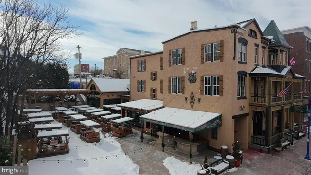 a aerial view of a house with barbeque grill and outdoor seating