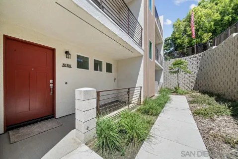 a front view of a house with a garden