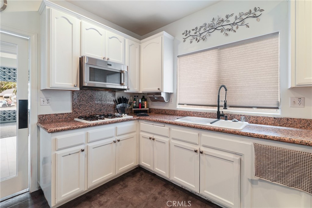 1842 Balboa Way Upland, CA 91784 - Photo 16 of 70 a kitchen with white cabinets white appliances and sink
