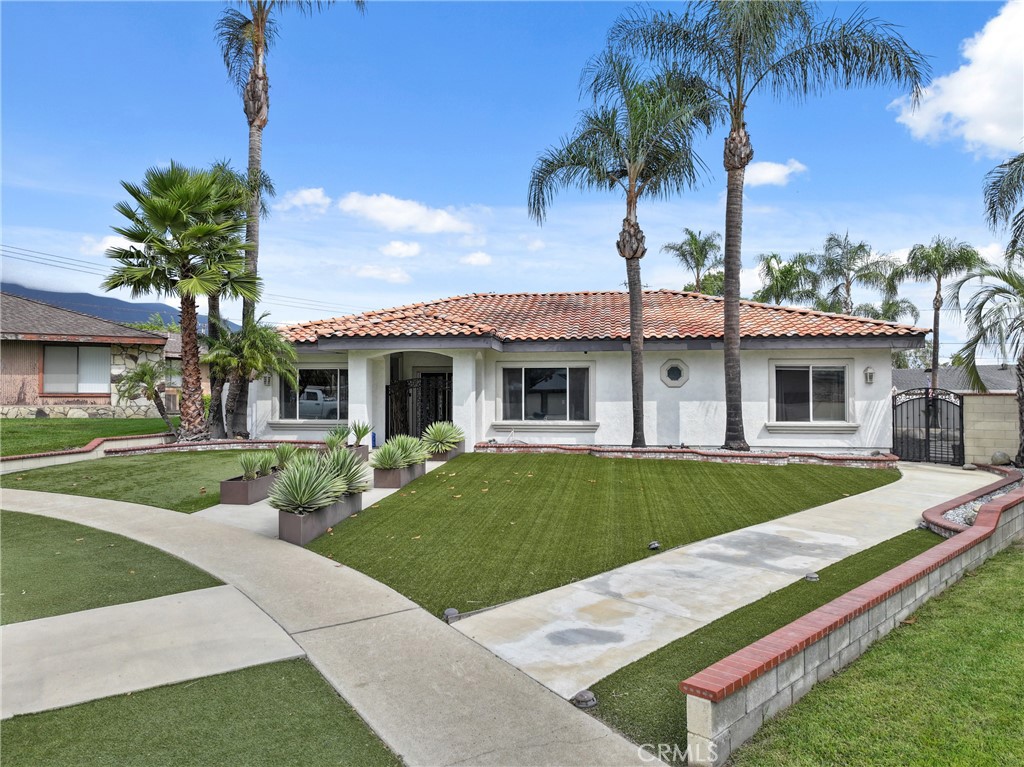 1842 Balboa Way Upland, CA 91784 - Photo 2 of 70 a front view of a house with a garden and yard
