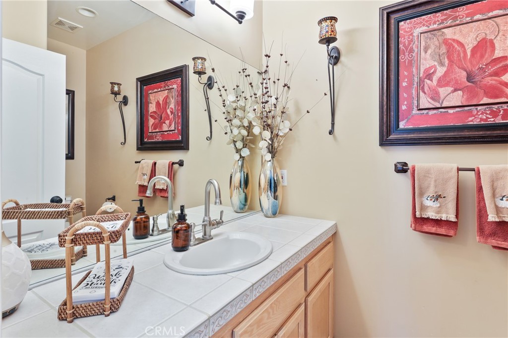 1842 Balboa Way Upland, CA 91784 - Photo 28 of 70 a bathroom with a sink mirror and vanity