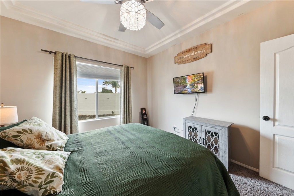 1842 Balboa Way Upland, CA 91784 - Photo 35 of 70 a bedroom with a bed and a chandelier