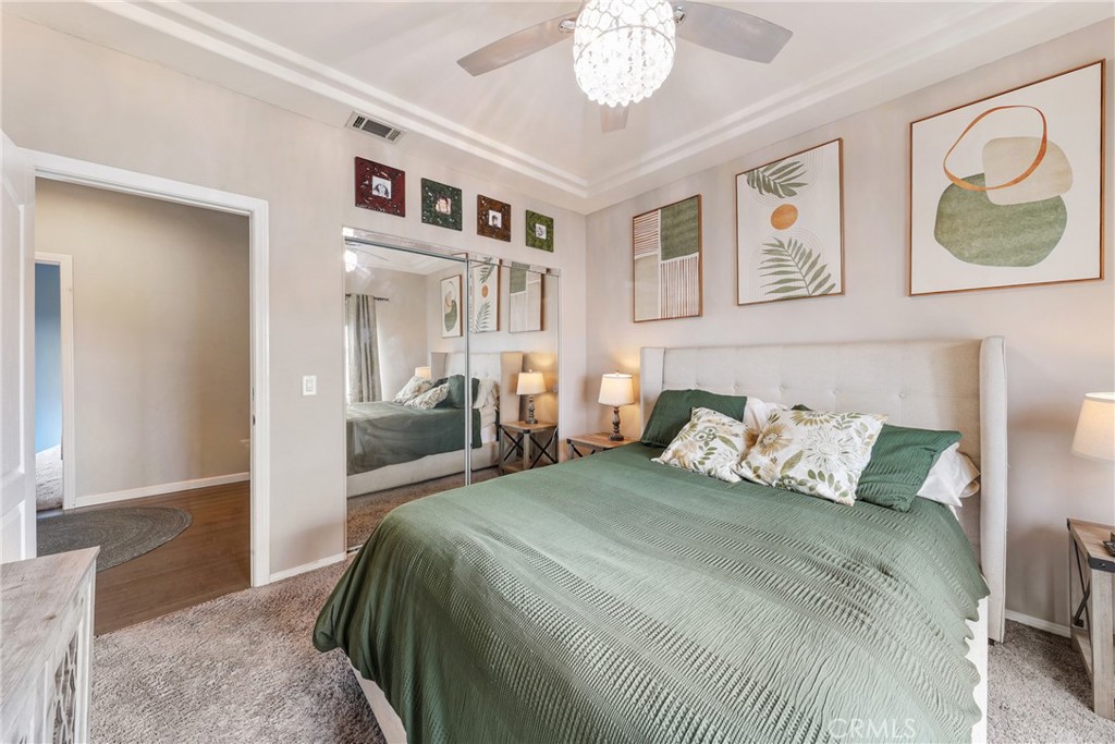 1842 Balboa Way Upland, CA 91784 - Photo 36 of 70 a bedroom with a large bed and a chandelier