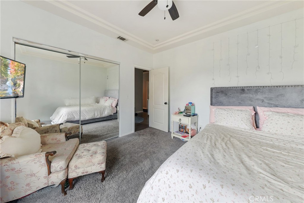 1842 Balboa Way Upland, CA 91784 - Photo 40 of 70 a bedroom with a bed a couch and a chandelier