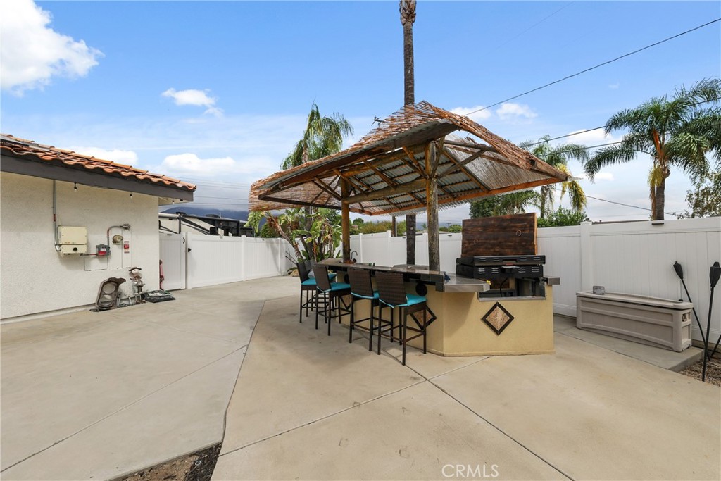 1842 Balboa Way Upland, CA 91784 - Photo 56 of 70 a view of a patio with a table and chairs under an umbrella