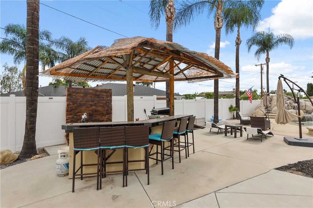 1842 Balboa Way Upland, CA 91784 - Photo 57 of 70 a view of patio with a table and chairs under an umbrella