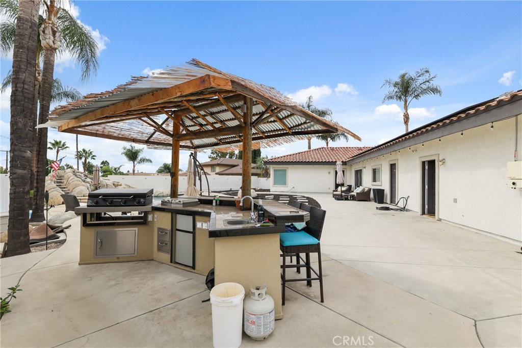 1842 Balboa Way Upland, CA 91784 - Photo 58 of 70 a view of a patio with a table and chairs under an umbrella