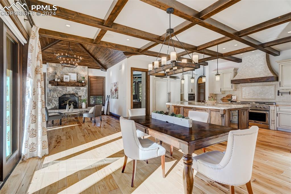4602 High Forest Road Colorado Springs, CO 80908 - Photo 12 of 50 a dining room with furniture a fireplace and wooden floor