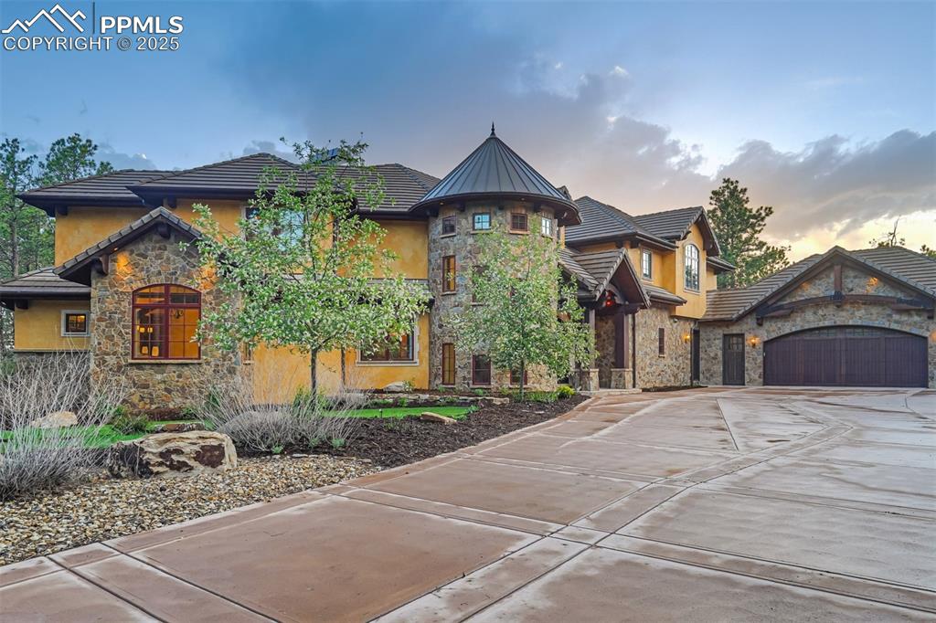 4602 High Forest Road Colorado Springs, CO 80908 - Photo 2 of 50 a front view of a house with a yard and garage