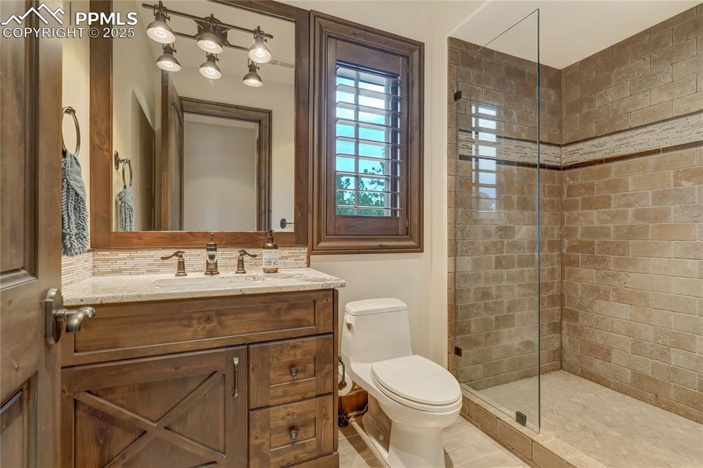 4602 High Forest Road Colorado Springs, CO 80908 - Photo 32 of 50 a bathroom with a sink a toilet and shower