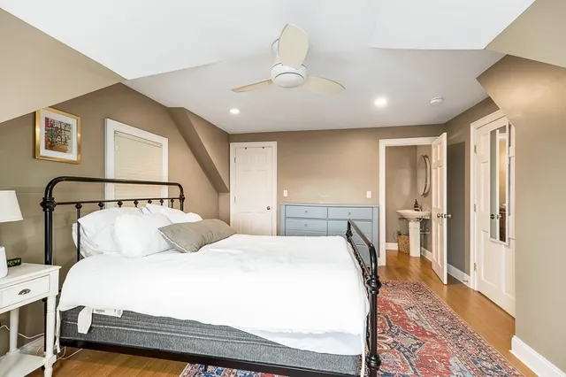 a bedroom with a large bed and a rug