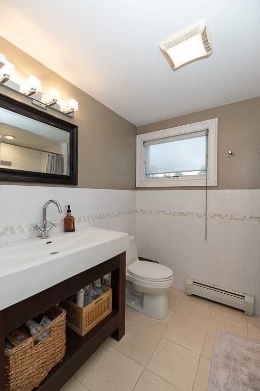 160 Prospect Street, Unit 3 Gloucester, MA 01930 - Photo 12 of 22 a bathroom with a sink a toilet and mirror