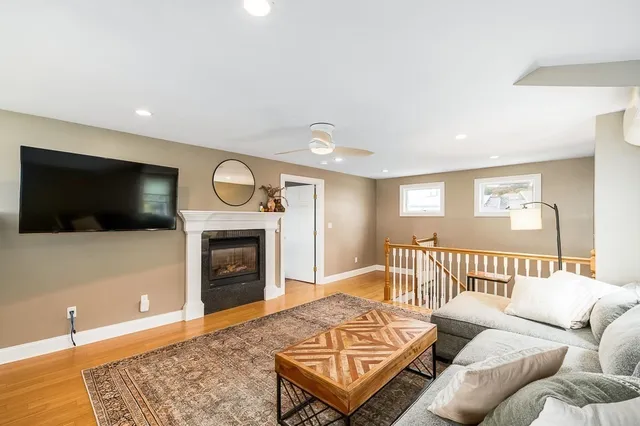 a living room with furniture a flat screen tv and a fireplace