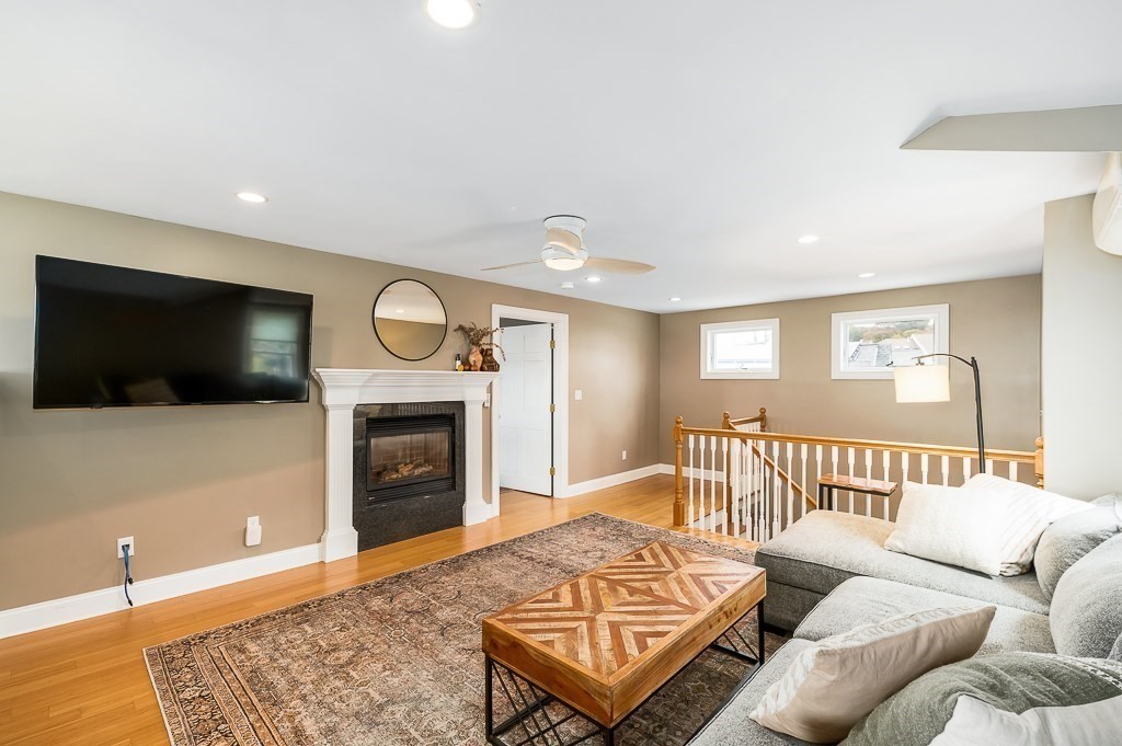 160 Prospect Street, Unit 3 Gloucester, MA 01930 - Photo 4 of 22 a living room with furniture a flat screen tv and a fireplace