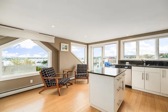 a very nice looking living room with kitchen island furniture and a large window