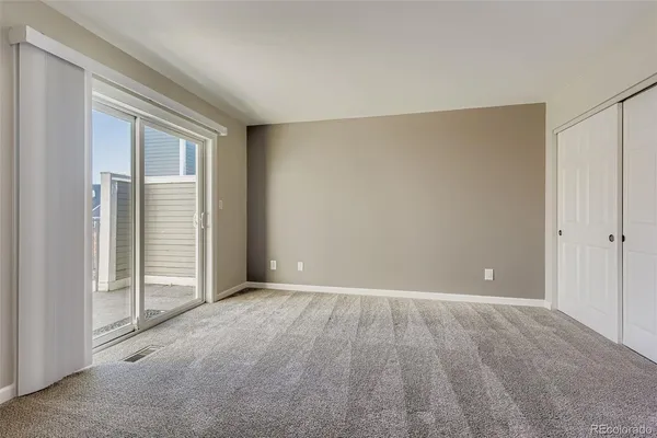 a view of an empty room with closet area