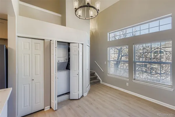 a view of a room with wooden floor and windows