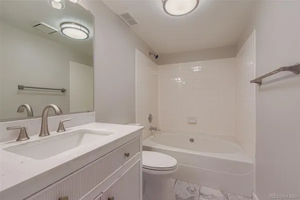 a bathroom with a sink a toilet and a bathtub