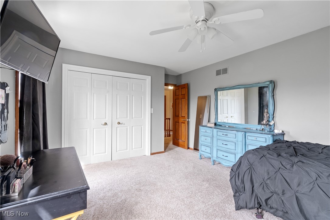 7285 South Raccoon Road Canfield, OH 44406 - Photo 29 of 46 Bedroom with a closet, carpet, and a ceiling fan