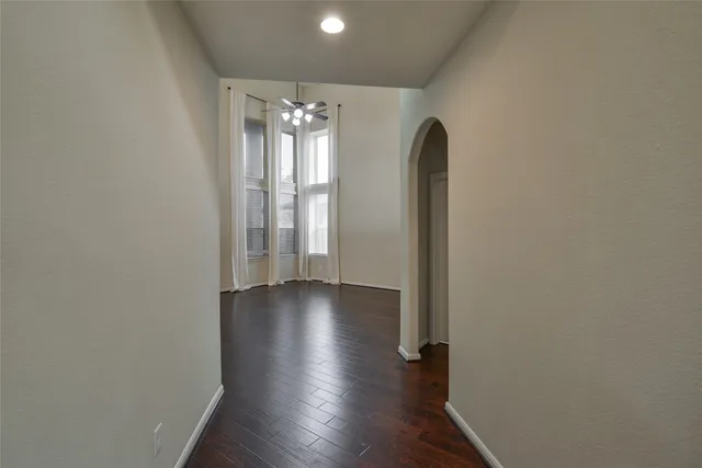 a view of a room with wooden floor and entryway