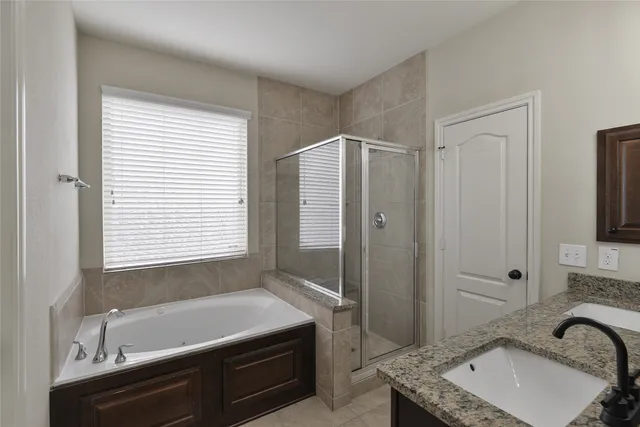 a bathroom with a tub sink and mirror