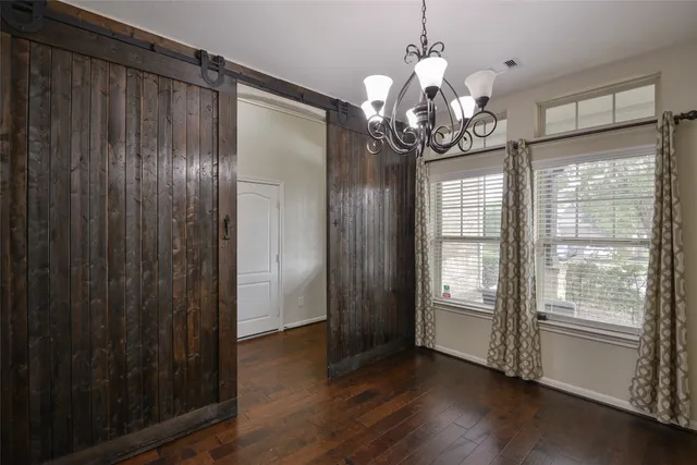 a view of a livingroom with wooden floor and a window