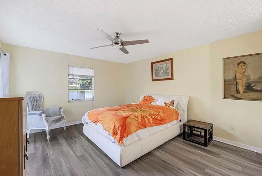 209 Bobolink Way, Unit A Naples, FL 34105 - Photo 10 of 17 a bed sitting in a bedroom and chair