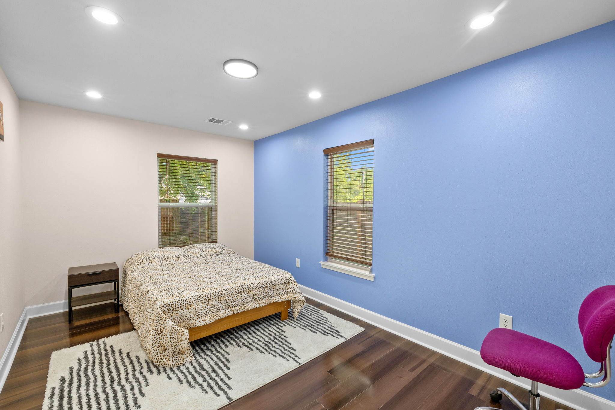 907 East 53rd Street Austin, TX 78751 - Photo 20 of 36 A restful chamber offers sleek hardwood floors and ample natural illumination through dual windows.