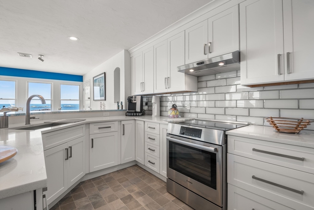 66 Glades Road, Unit 8 Scituate, MA 02066 - Photo 13 of 27 a kitchen with cabinets stainless steel appliances and a sink