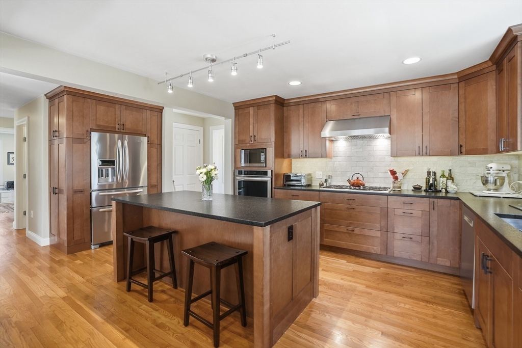 25 Bold Meadow Road Edgartown, MA 02539 - Photo 3 of 40 a kitchen with granite countertop a table chairs stove and cabinets