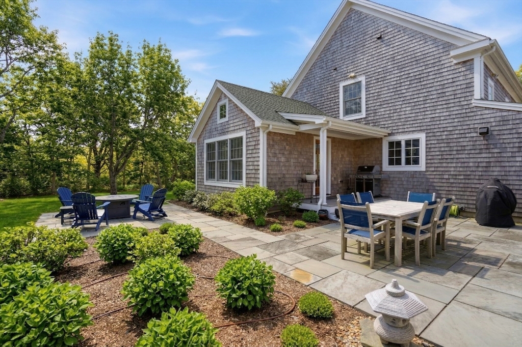 25 Bold Meadow Road Edgartown, MA 02539 - Photo 34 of 40 a view of a patio with table and chairs and potted plants