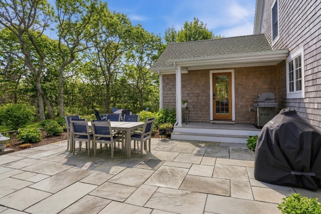 25 Bold Meadow Road Edgartown, MA 02539 - Photo 35 of 40 a view of a patio with table and chairs