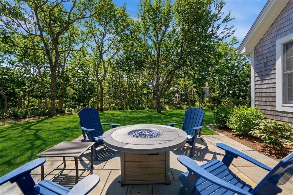 25 Bold Meadow Road Edgartown, MA 02539 - Photo 36 of 40 a view of a table and chairs in patio of the house