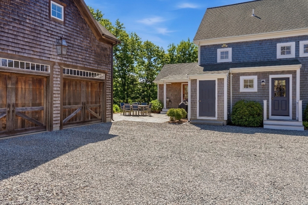 25 Bold Meadow Road Edgartown, MA 02539 - Photo 37 of 40 a view of a house with a yard and potted plants