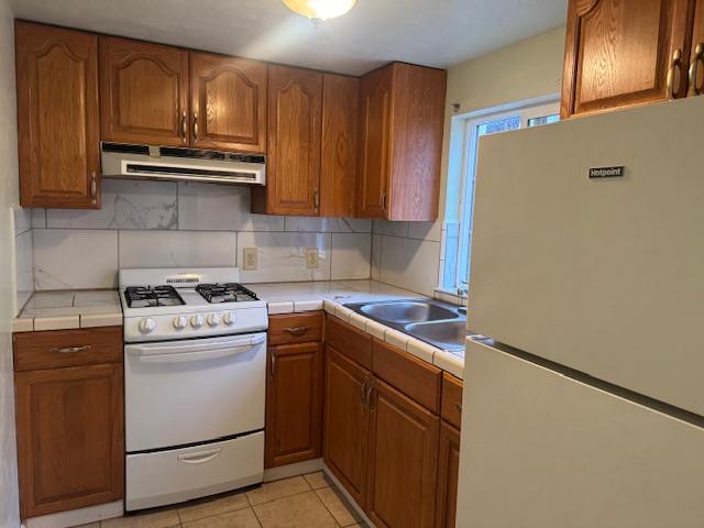 a kitchen with a stove sink and cabinets
