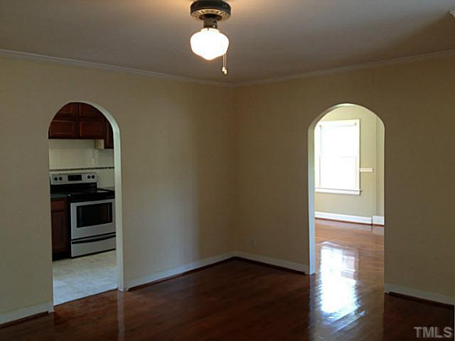813 Welford Road Raleigh, NC 27610 - Photo 11 of 17 a view of a livingroom with wooden floor and a kitchen space