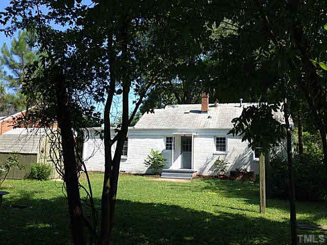 813 Welford Road Raleigh, NC 27610 - Photo 17 of 17 a view of a white house with a big yard and large tree