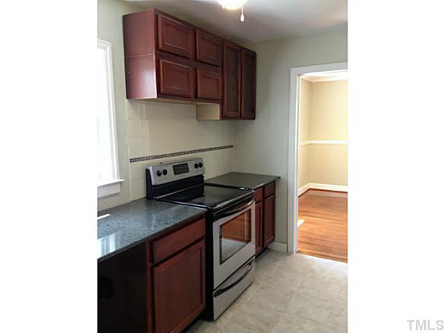 813 Welford Road Raleigh, NC 27610 - Photo 5 of 17 a kitchen with stainless steel appliances granite countertop a sink stove and microwave