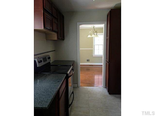 813 Welford Road Raleigh, NC 27610 - Photo 7 of 17 a kitchen with a stove and a refrigerator