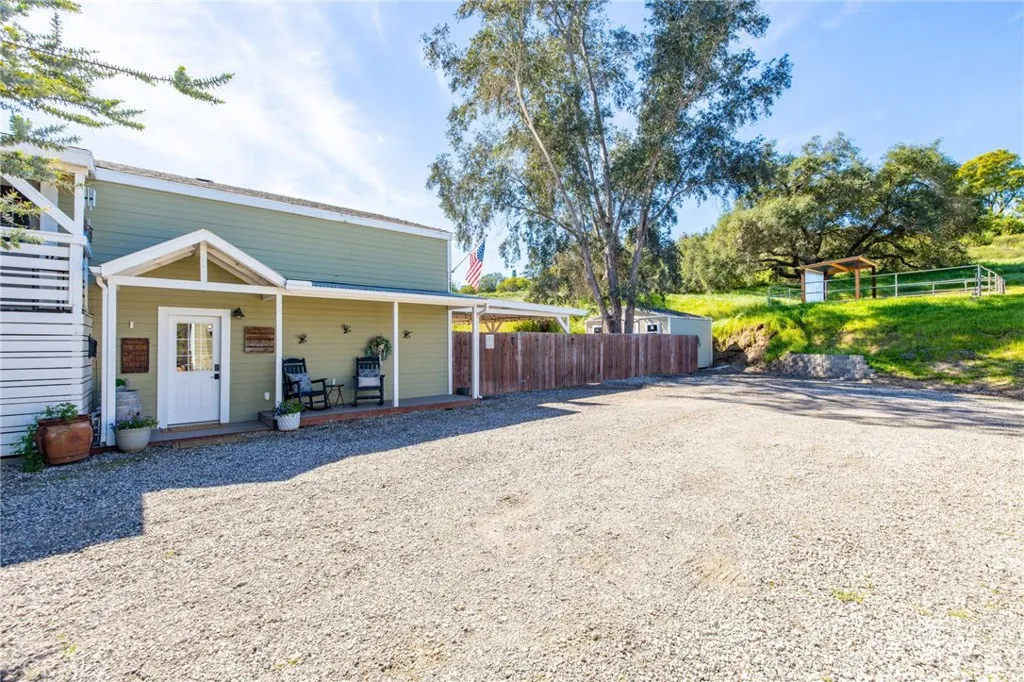 a view of a house with a backyard and a patio