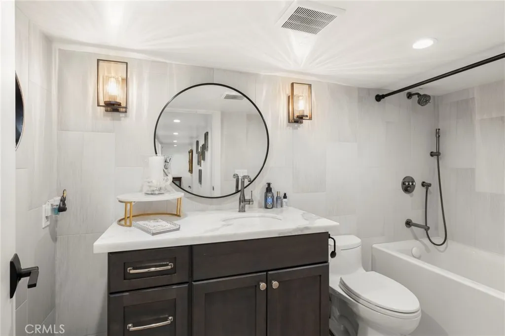 1720 Vista Del Lago, Unit 2 Fallbrook, CA 92028 - Photo 24 of 54 a bathroom with a toilet a sink and a mirror