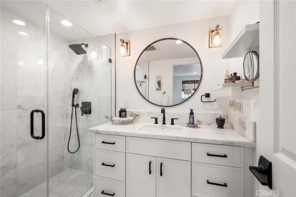 1720 Vista Del Lago, Unit 2 Fallbrook, CA 92028 - Photo 29 of 54 a bathroom with a double vanity sink mirror and glass door