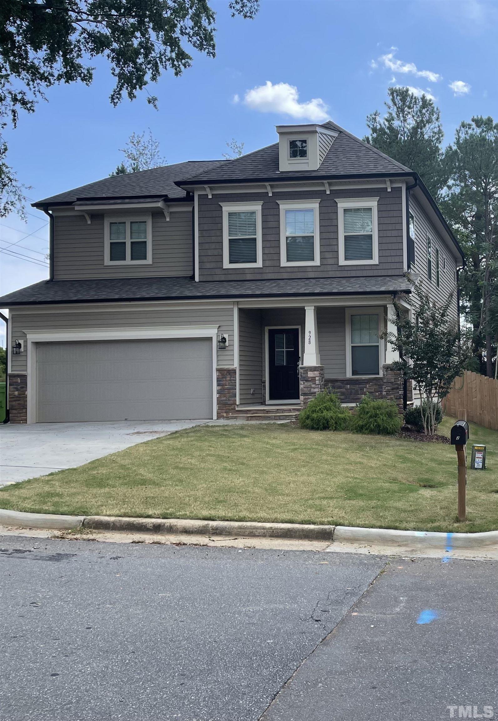 a front view of a house with a garden and yard
