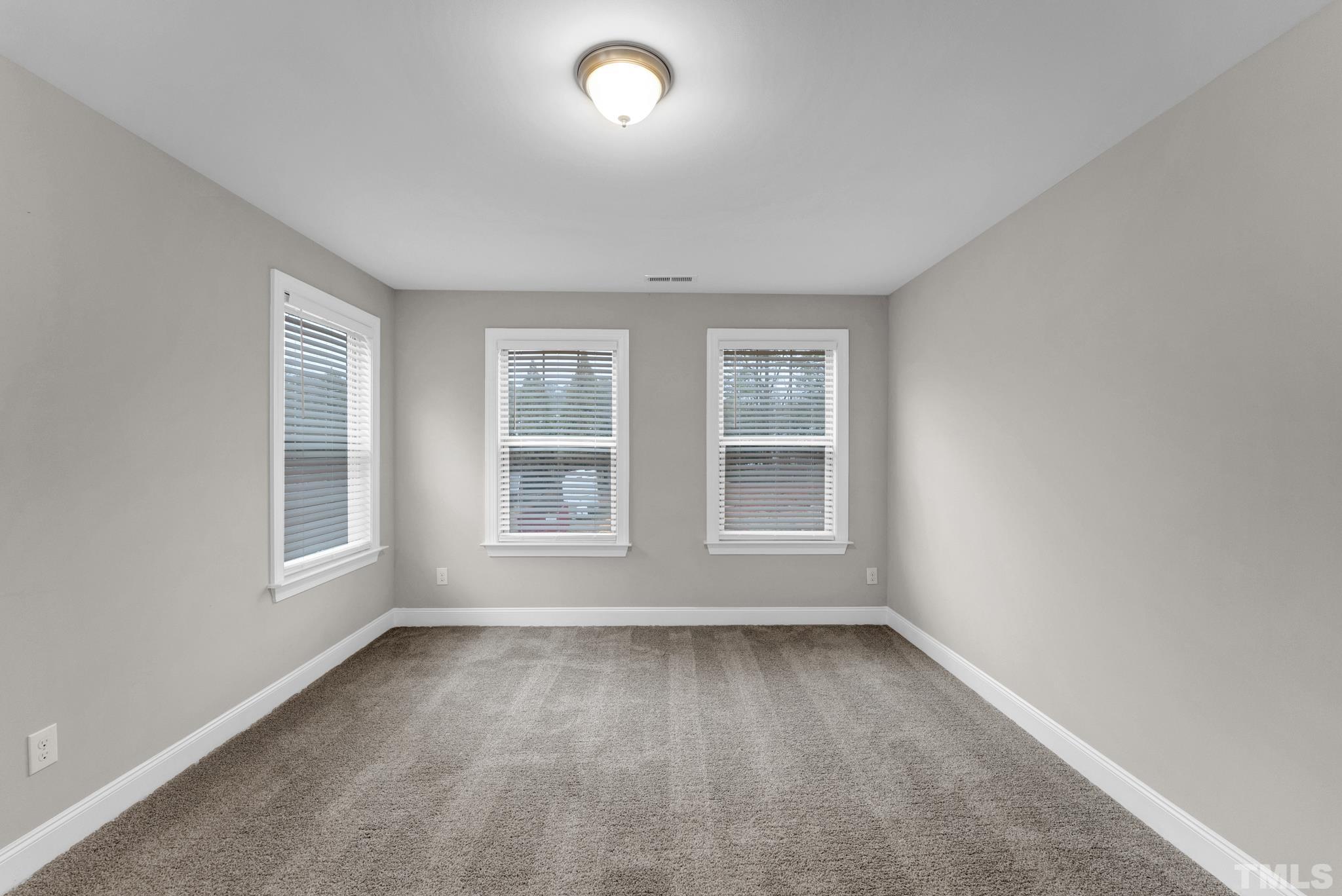 928 Barringer Drive Raleigh, NC 27606 - Photo 14 of 32 an empty room with a window