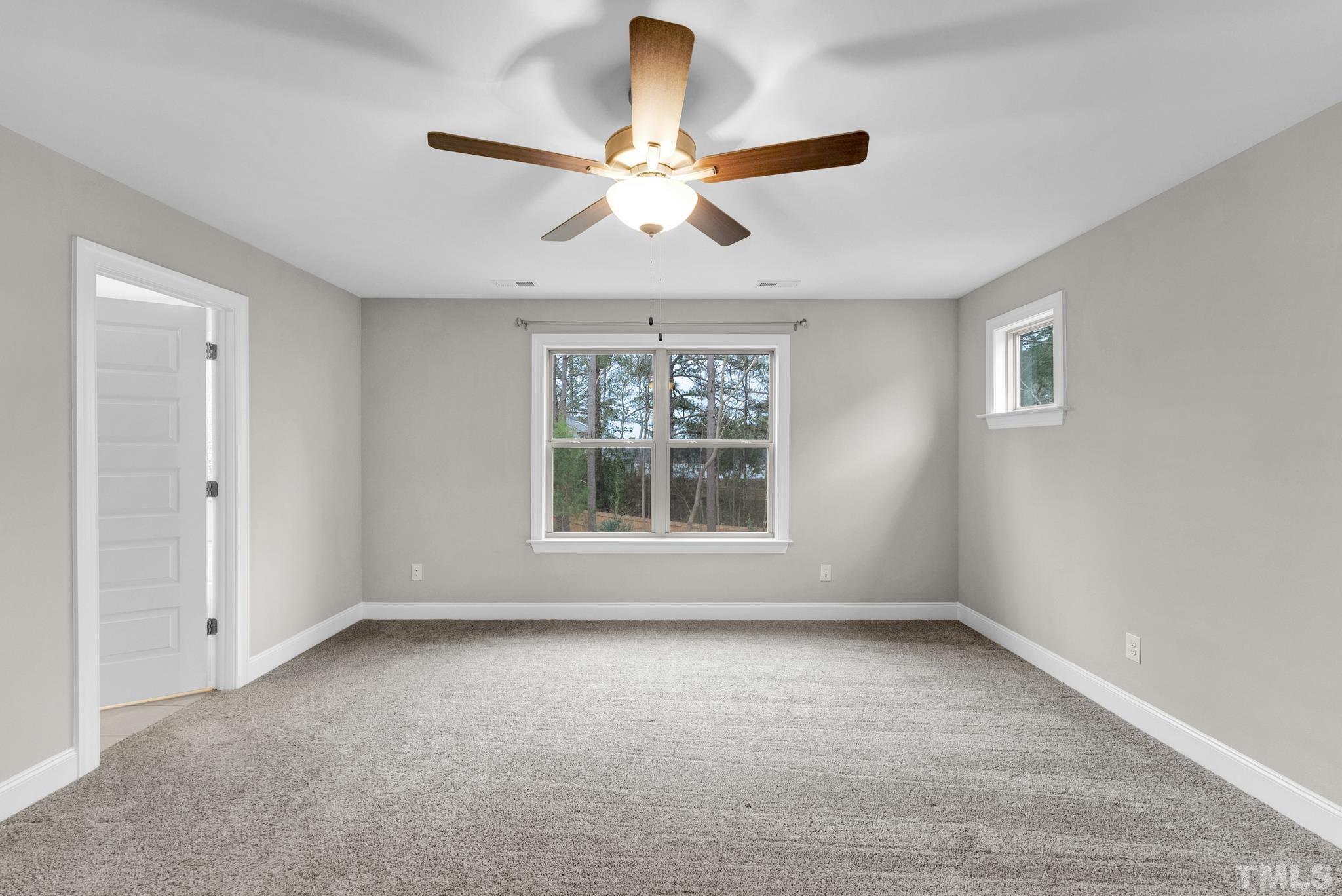 928 Barringer Drive Raleigh, NC 27606 - Photo 16 of 32 an empty room with chandelier fan and windows