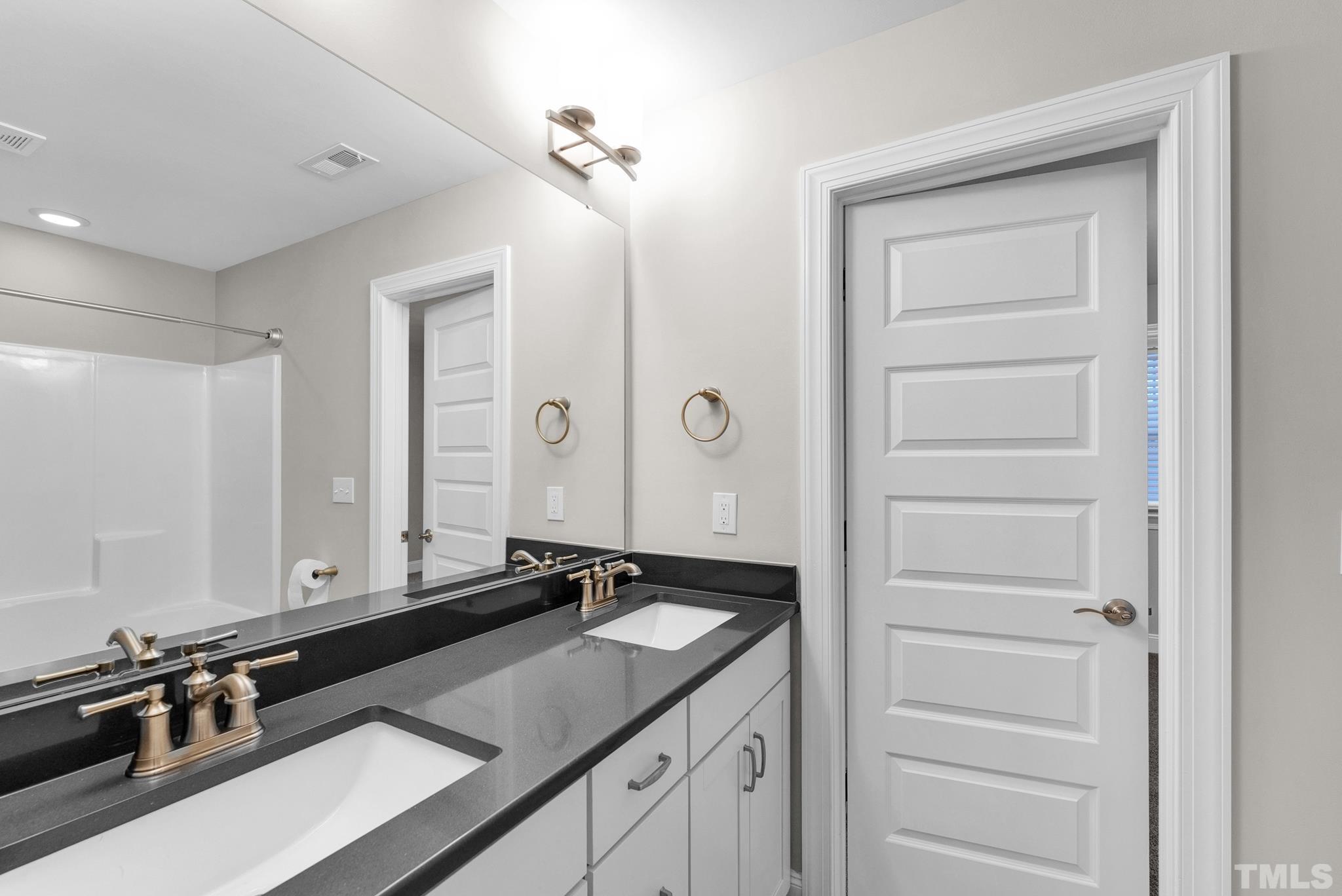 928 Barringer Drive Raleigh, NC 27606 - Photo 22 of 32 a bathroom with a sink and a mirror