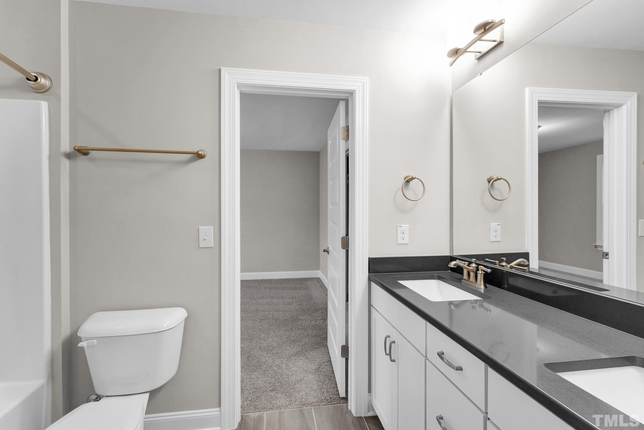 928 Barringer Drive Raleigh, NC 27606 - Photo 23 of 32 a bathroom with a sink and a mirror