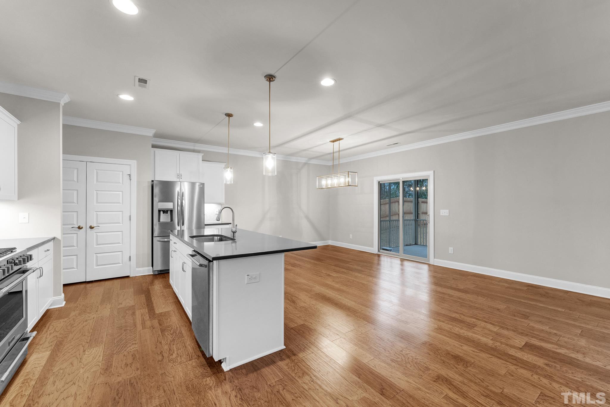 928 Barringer Drive Raleigh, NC 27606 - Photo 3 of 32 a kitchen with stainless steel appliances granite countertop a sink and cabinets