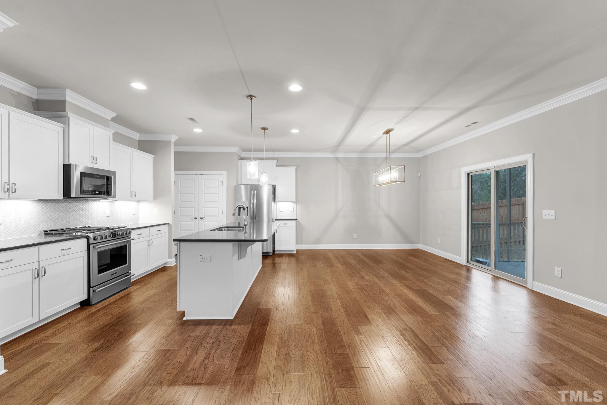 928 Barringer Drive Raleigh, NC 27606 - Photo 4 of 32 a large kitchen with stainless steel appliances granite countertop a stove and a refrigerator