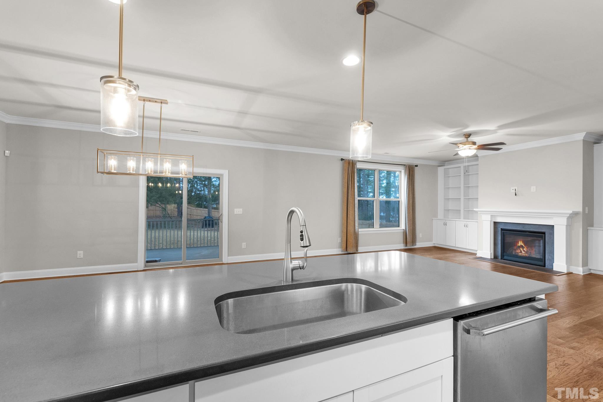 928 Barringer Drive Raleigh, NC 27606 - Photo 7 of 32 a kitchen with a sink and chandelier